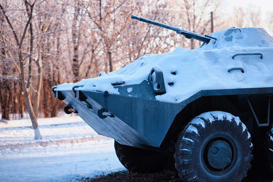 Tank under the snow in the forest. Winter tank camouflage. Battle tank in the snow on the roadside of highway. War in Ukraine in winter.
