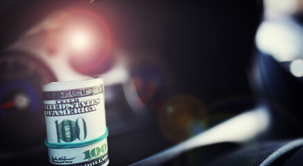 Concept background. dollars with a car key lie in inside cars. financial concept
