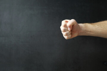 Male hands on a gray background. Finger gestures. Gesticulation with hands.