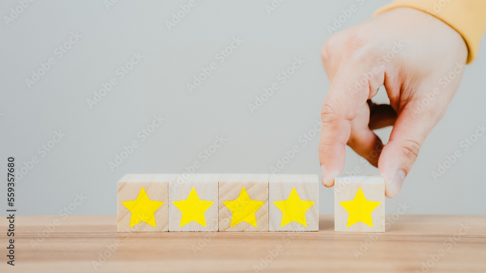 Aufkleber customer's hand selects a star icon on a wooden cube block with 5 star satisfaction. best great busi