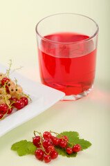 Fresh red and white currant berries and a cup of fruit juice - 559361272