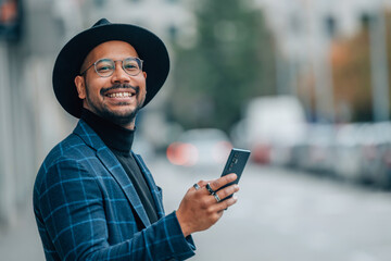 latin american businessman with mobile phone in the street