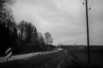 country road over forests and fields in Latvia. Sēlija landscape. Road Jaunjelgava - Jēkabpils