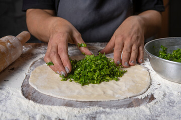 chef making dough with flour and herbs