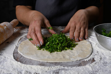 chef making dough with flour and herbs
