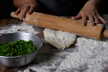 chef making dough with flour and herbs