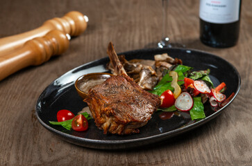 grilled beef steak with vegetables and spices on wooden table