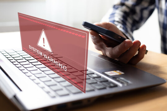 Malware cyber crime and Personal Data Protection Act concept.Close up hand of anonymous hacker and uses a malware with mobile phone to hack password the money from Bank accounts and personal data.