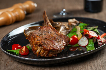 grilled beef steak with vegetables and spices on wooden table