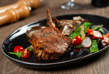 grilled beef steak with vegetables and spices on wooden table