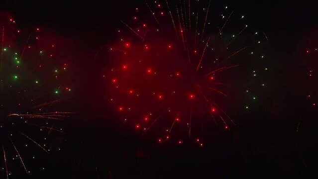 Colorful fireworks festival. Beautiful fireworks close-up view in slow motion. Wonderful real fireworks in the night sky shot with a telephoto lens. fireworks show. 4K slow motion video.