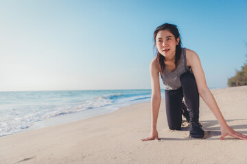 Athlete sport female stretching and exercise workout on the beach in day time, Wellness, training and warm up athlete on the coast to start running