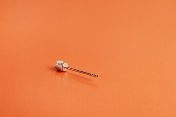 Needle for inflating the ball. Sports equipment.