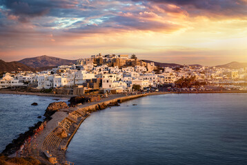 Fototapeta premium Panoramic view of the city and port of Naxos island, Cyclades, Greece, during a beautiful summer sunset