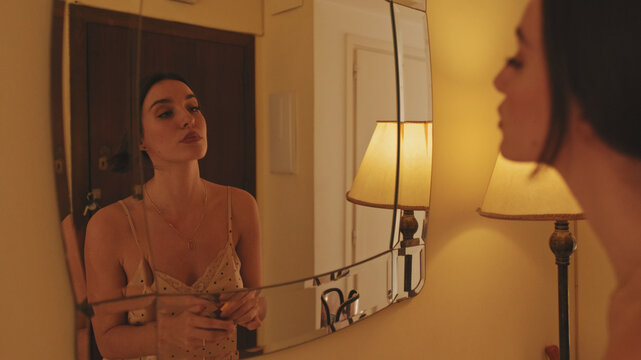 Close Up, Young Woman Putting On Makeup While Standing In Front Of Mirror