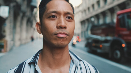 Young man standing next to the road