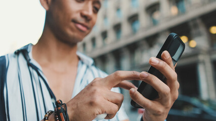 Close-up of man's hands using mobile phone