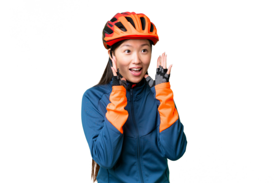 Young cyclist woman over isolated chroma key background with surprise facial expression