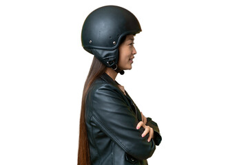 Young Asian woman with a motorcycle helmet over isolated chroma key background in lateral position