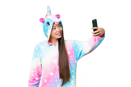 Young Asian woman with unicorn pajamas over isolated chroma key background making a selfie