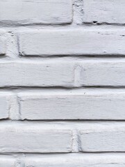 Detail of white painted brick wall vertical geometric background texture