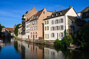 Naklejka na ściany i meble Strasbourg, France: Buildings by the river in city centre. 