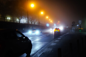 Cars driving through the fog in a winter night in Budapest, Hungary