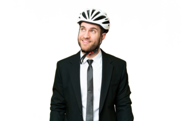 Business person with a bike helmet over isolated chroma key background thinking an idea while looking up