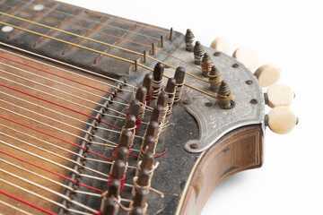 High angle studio shot of vintage, old wooden zither isolated on white background. Detail of zither...