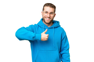 Young handsome blonde man over isolated chroma key background giving a thumbs up gesture