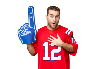 sports fan man over isolated chroma key background surprised and shocked while looking right