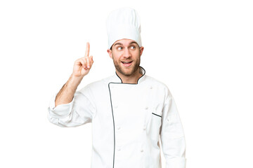 Young blonde man Chef over isolated chroma key background intending to realizes the solution while...