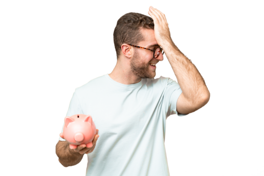 Young man holding a piggybank over isolated chroma key background has realized something and intending the solution