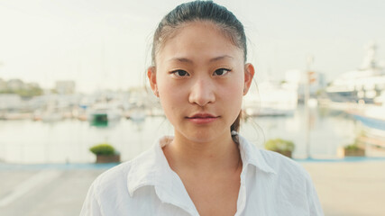 Close up, young woman looking at the camera