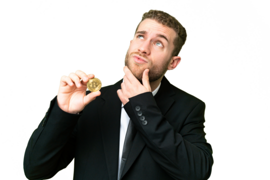 Young business blonde man holding a Bitcoin over isolated chroma key background having doubts