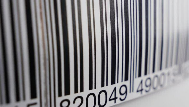 Barcode label scanning with red laser strip. Production line, close up shot