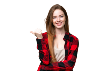 Young pretty woman over isolated chroma key background pointing to the side to present a product