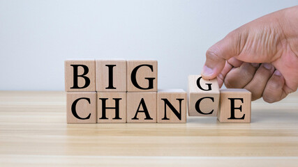 Hand flipping wooden cubes for change wording between "Big change" to "Big chance".Mindset for career growth business.