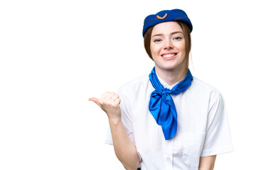Airplane stewardess over isolated chroma key background pointing to the side to present a product