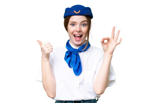 Airplane stewardess over isolated chroma key background showing ok sign and thumb up gesture - Powered by Adobe