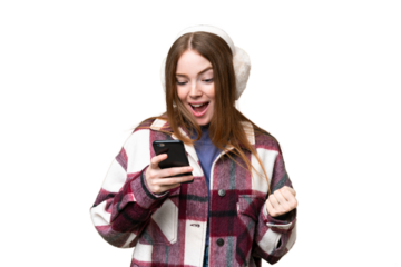 Young pretty woman wearing winter muffs over isolated chroma key background surprised and sending a message