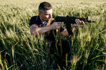 The man in the field with a machine gun, Ukrainian men prepare for the war.
