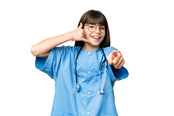 Little girl as a surgeon doctor over isolated chroma key background making phone gesture and pointing front