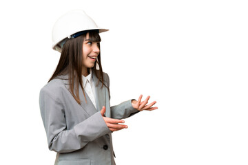 Little girl playing as a architect with helmet and holding blueprints over isolated background with...