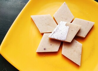 Kaju katli also known as kaju barfi, is an Indian dessert prepared with ground cashew nuts and sugar. The diamond shaped pieces are usually decorated with edible silver foil.