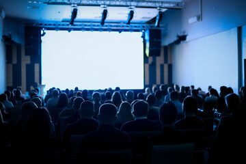 Back view of Audience listening speakers in the conference hall or seminar meeting, business and...