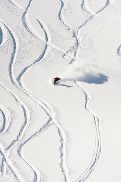 Sandra Hillen Riding Snowboard Through Powder In The Japanese Alps