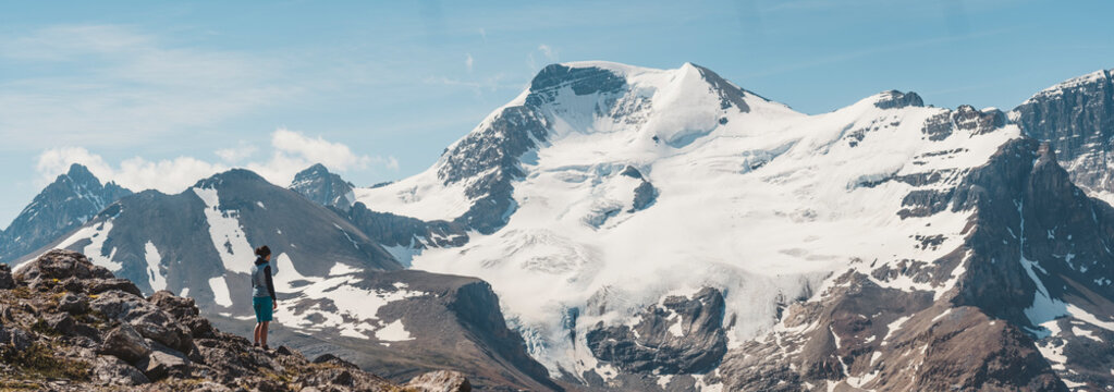Hiker admiring scenic mountains, Alberta, Canada