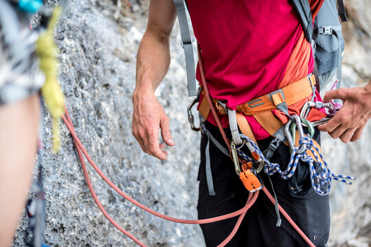 Rapelling above the sea while hiking on Selvaggio Blu, Sardinia, Italy.