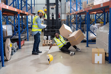 African american working in warehouse got accident from carry box, forklift truck working near by - obrazy, fototapety, plakaty